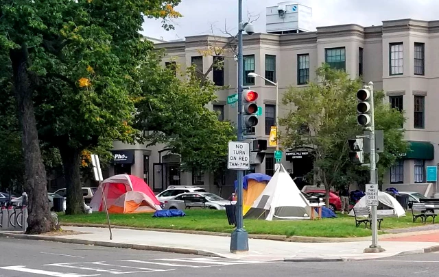 Low-income housing, 2nd St. and Massachusetts Ave. NE, one block from the Ronald Reagan Republican Center, Capitol Hill, Washington, D.C. September 29, 2020. Tents set up in a park at a city intersection.