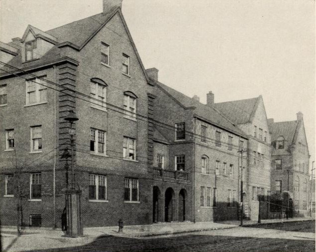 Exterior of Hull House complex along Halsted showing many buildings