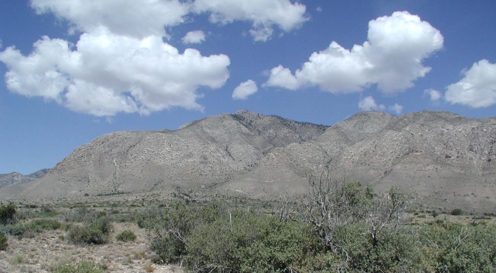A mountain ridge rises above the desert