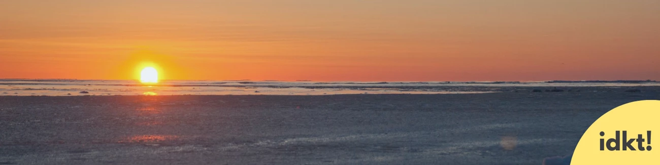 Winter Solstice a winter sunset over water with text IDKT!