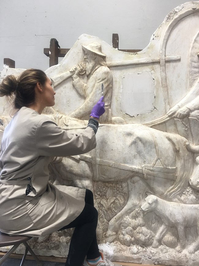 Alex Beard filling areas of loss on the plaster relief. Alex Beard filling areas of loss on the plaster relief.