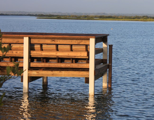 CANA Fixed Station Site Dock at the edge of water with a pvc pipe attached.