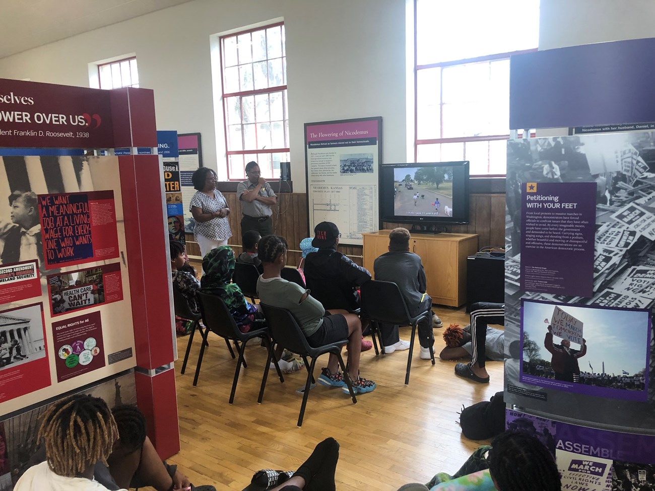 A group of teens watching the park film during the Voices and Votes event