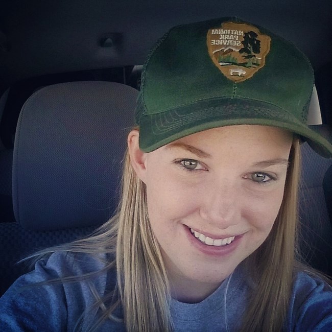 Elise a selfie of a young woman in a park service ball cap