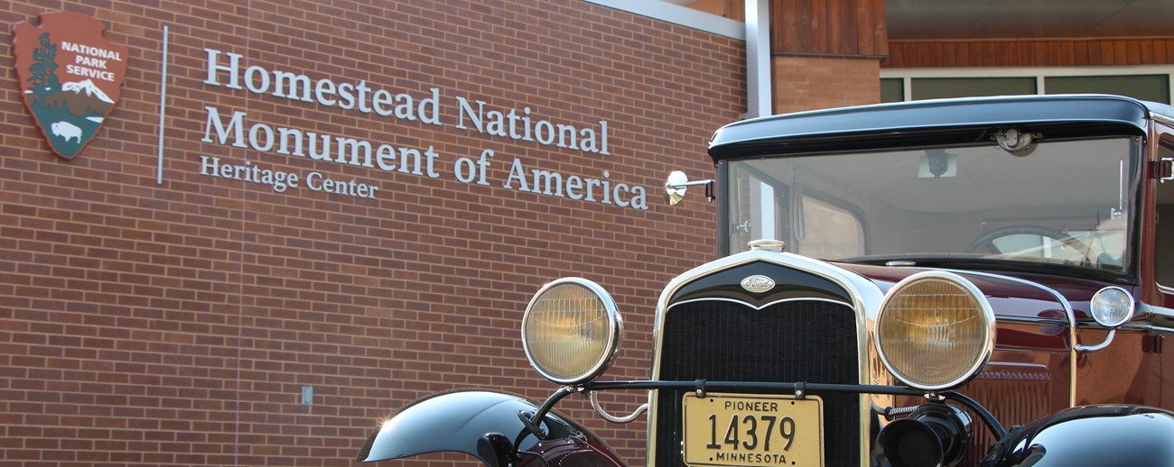 A model A sits outside the brick visitor center