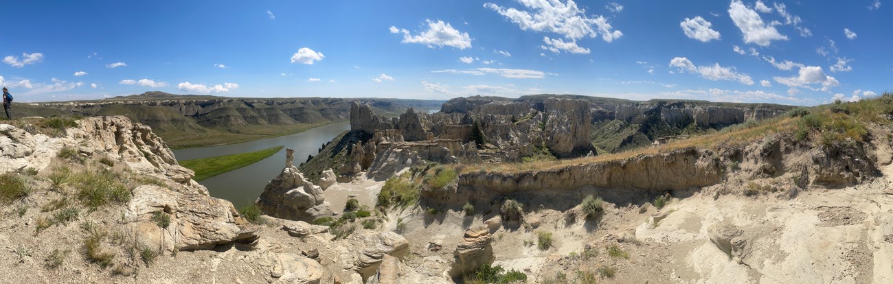 rocky valley with a river in the background