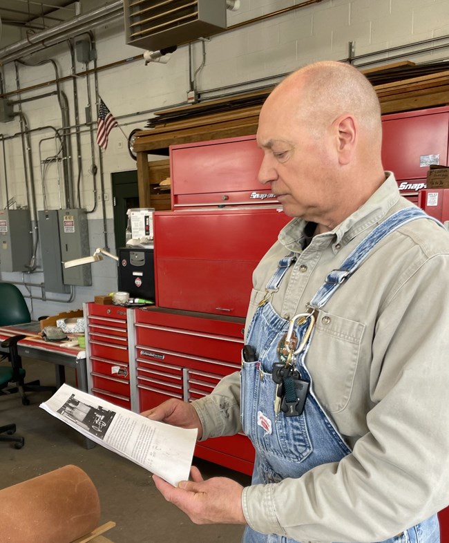 John Bibalo reading historic document. John Bibalo reading historic document to ensure historical accuracy during the restoration.