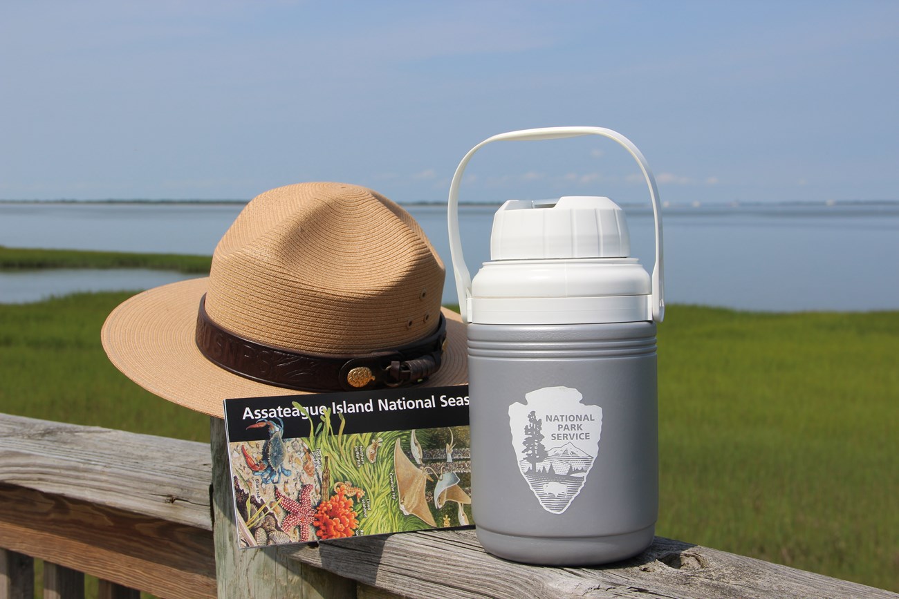 The Park Ranger iconic hat accompanied by Assateague's Park map and an NPS water bottle