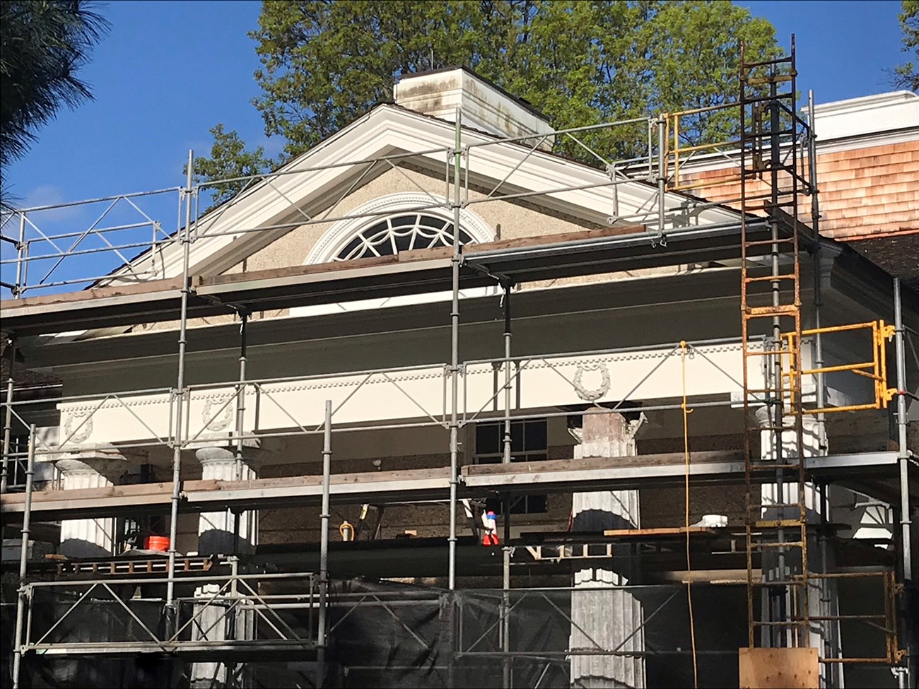 A classical building under repair and covered with scaffolding