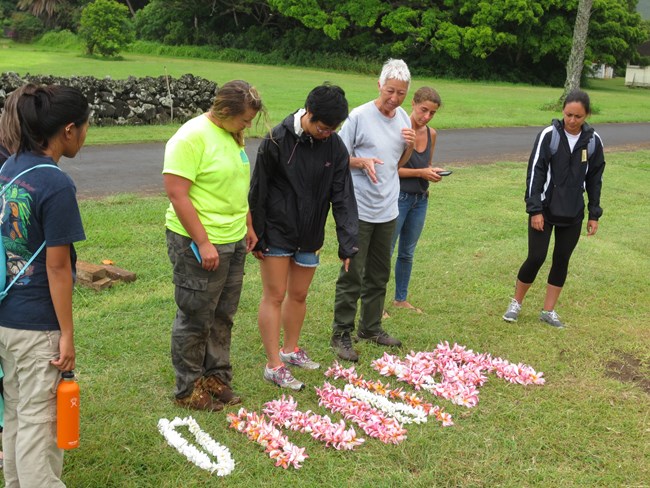 Ka`ohulani McGuire leads workshop participants in a ceremony to honor the graves that were conserved during the workshop Ka`ohulani McGuire leads workshop participants in a ceremony to honor the graves that were conserved during the workshop.