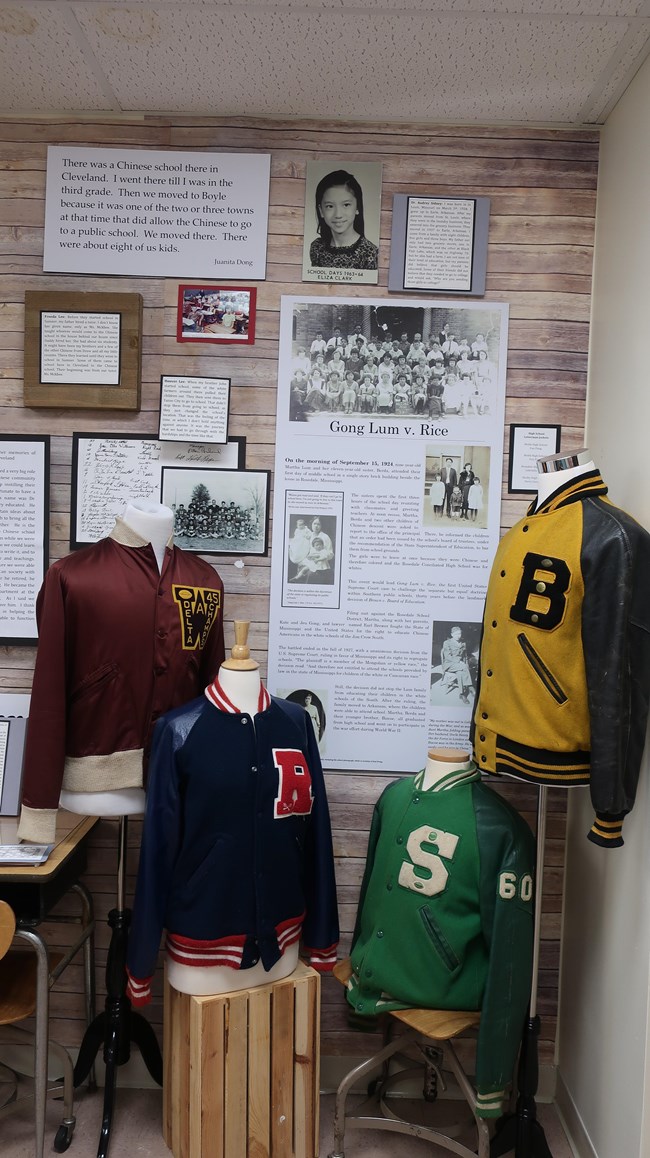Display board describing the Gong Lum v. Rice case with letter jackets in the foreground