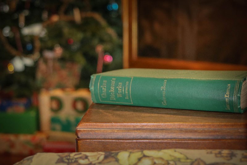 A book on a table with gilt lettering on the spine that says Charles Dickens Works