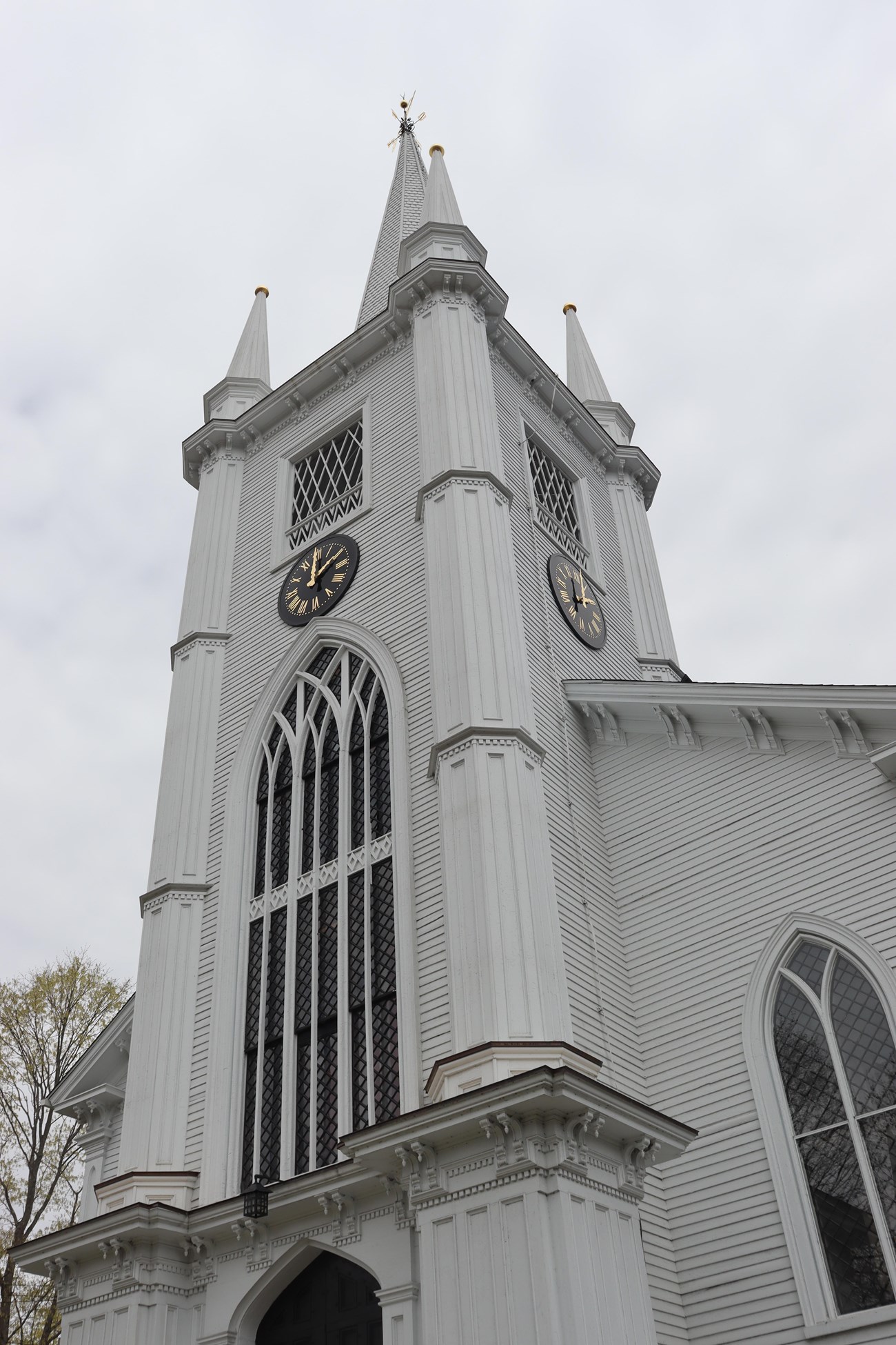 A white belltower with clock