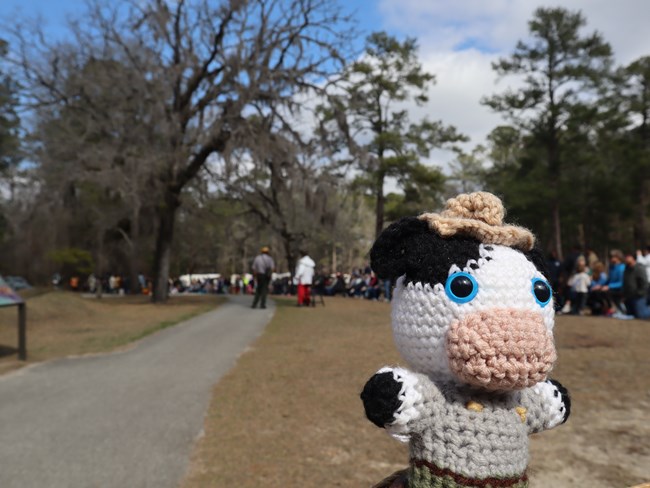 Crocheted Cow held in front of group