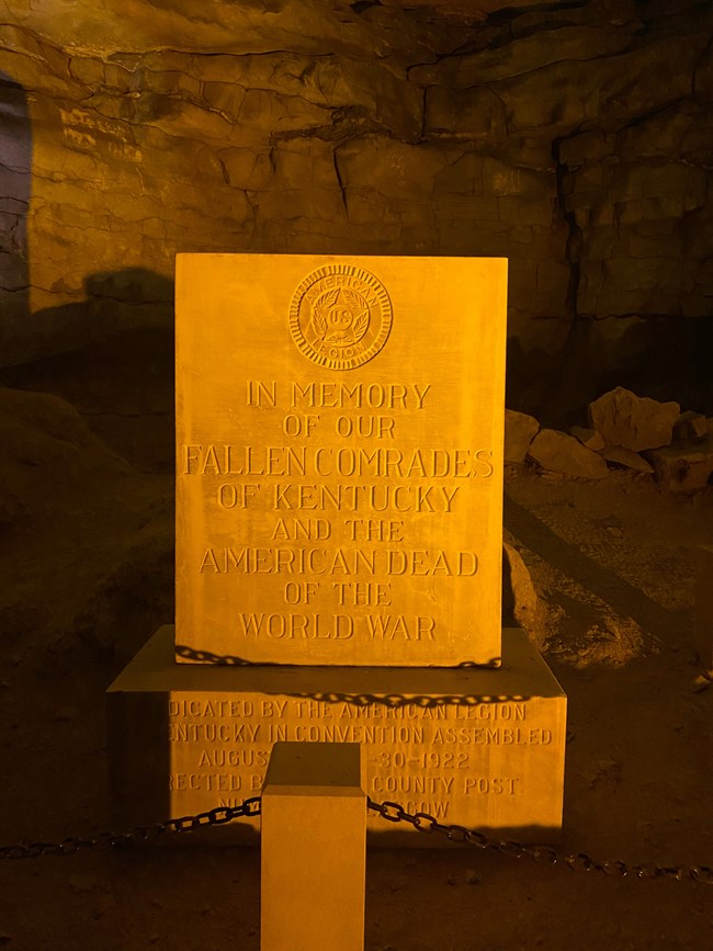 A large white stone with writing inscribed on the front.