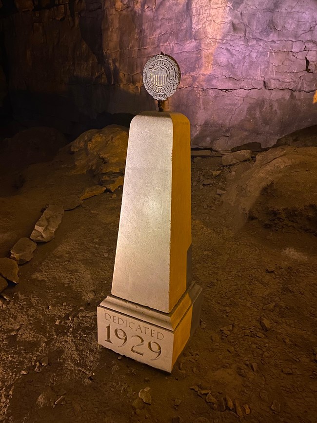 1929 American War Mothers monument A stone monument with the date 1929 and a round metal plaque on the top.