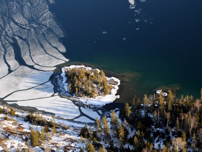 small island surrounded by floating ice