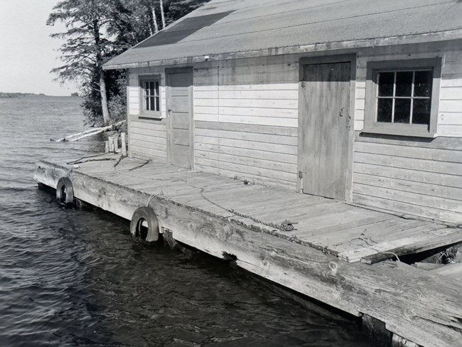 Anderson Fishery fish house with two windows and two doors, dock in front