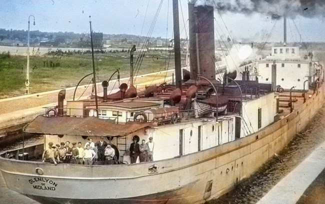 SS Glenlyon crew posing for photo on bow of docked boat