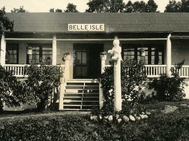 resort with carved statue in front and large sign displaying text of name