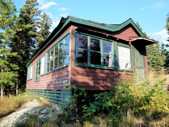 red cabin with many windows on front and side