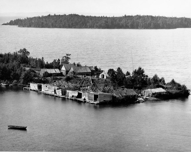 aerial view of Johns Brothers Fishery in the summer of 1896 with cabins, fish houses, and a garden in the center