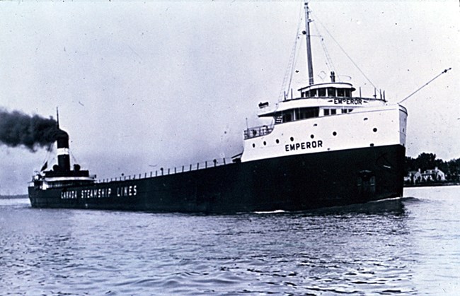 SS Emperor at sea and under power with brighter color scheme featuring wheelhouse and cabins in white and large white letters with company name emblazoned on sides