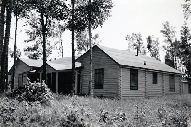 large, log cabin style lodge with multiple rooms