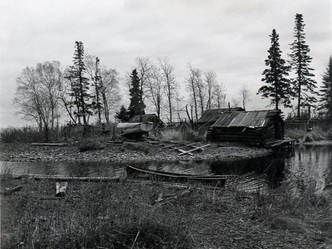 fishing cabin with boat and small harbor in the foreground