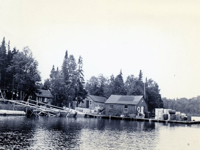 residence, net house, and fish house with many barrels out front