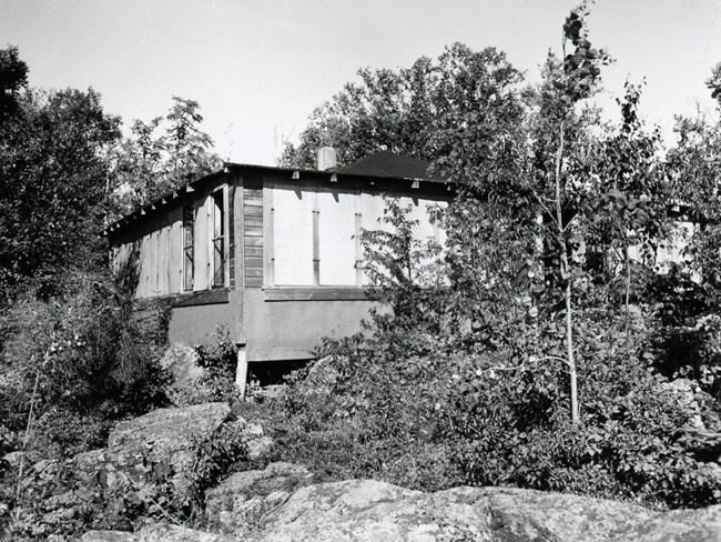 cabin with many windows all boarded up