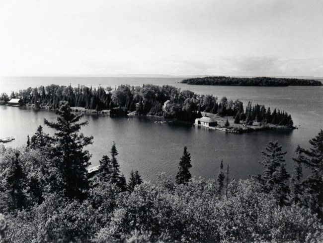 Barnum Island aerial view looking at an island, structures along shoreline, significant clearing at right tip