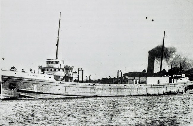 later view of SS Glenlyon under power with freight elevators and gangway hatch cranes