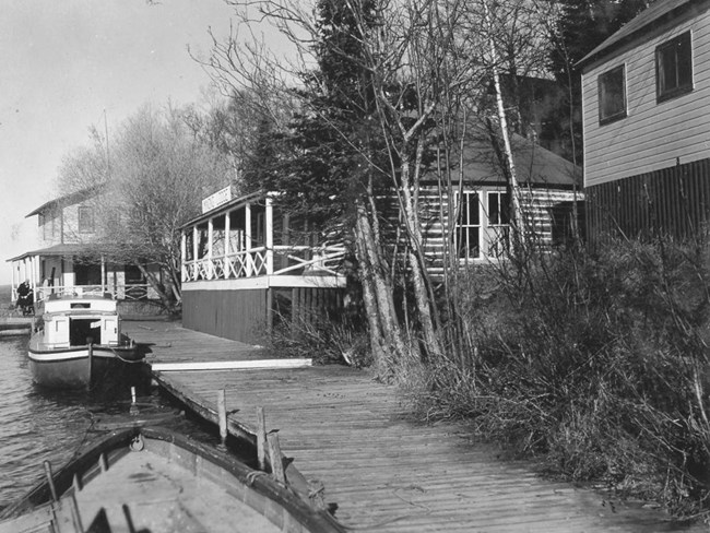 small boat docked in front of waterfront resort