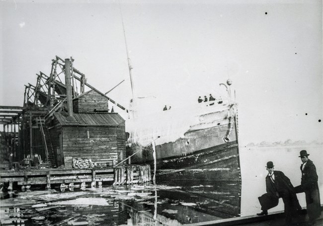 SS William H. Gratwick docked at Duluth and covered in ice and snow with onlookers