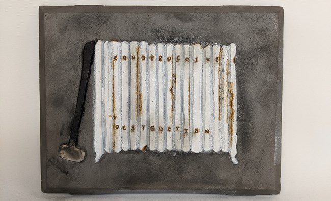A cast iron piece of art that depicts a radiator Cast iron piece depicting a radiator