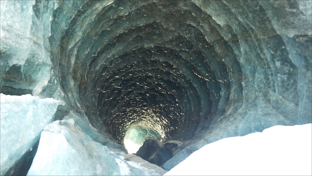 large arched tunnel in glacial ice