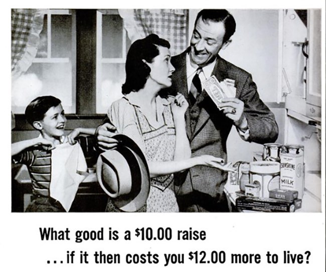 Black and white photo of a white family – man in a suit, woman in a dress and apron, and young boy. The man is smiling and showing the woman a fist full of dollars. She looks at him exasperated and points to groceries on the counter.