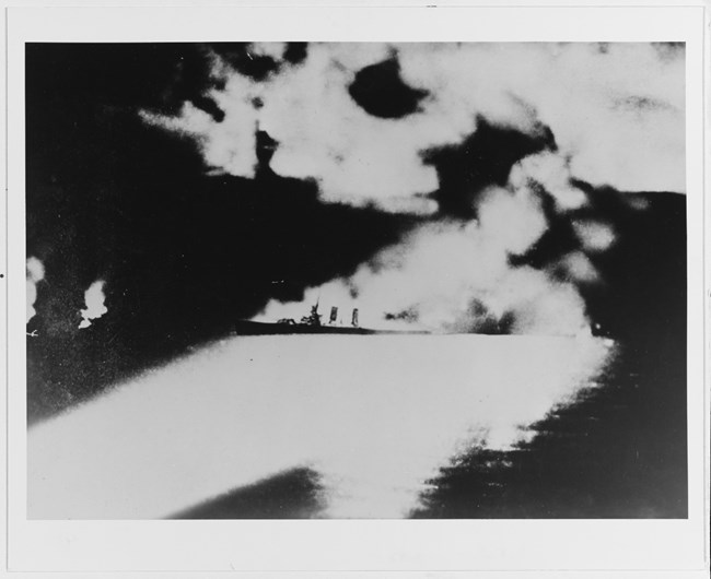 Last photograph of USS QUINCY, taken from a Japanese cruiser in the early hours of August 9th, 1942. QUINCY would sink soon after.