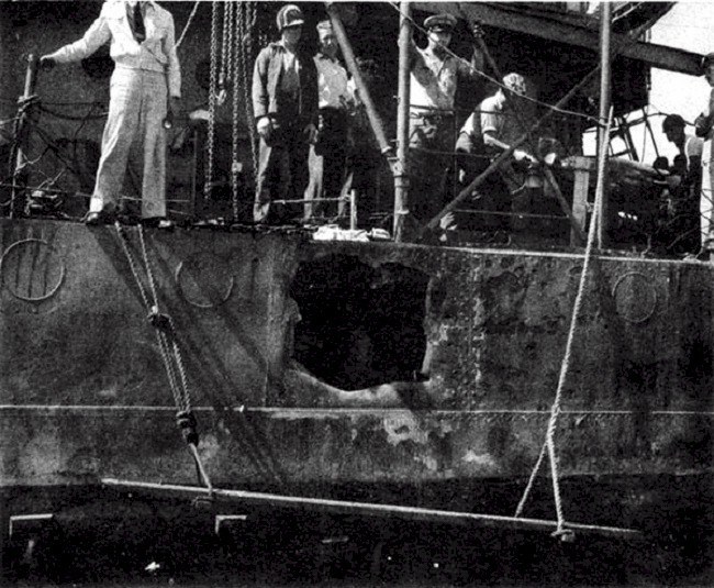 Shell hole on starboard (right) side of USS RALPH TALBOT after the Battle of Savo Island.