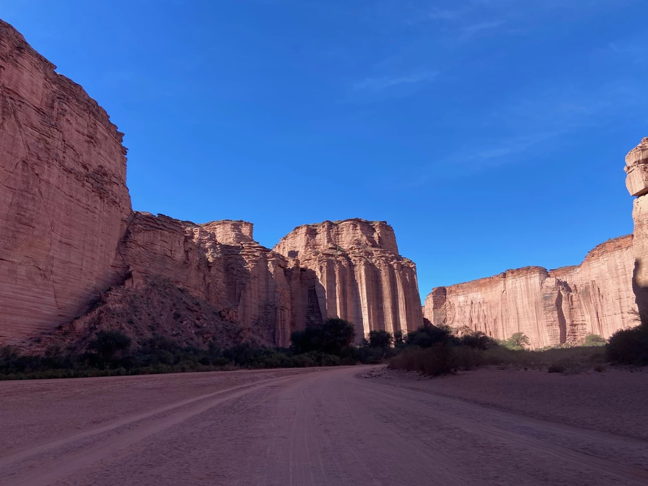 Image A Photo of a desert canyon with red rock walls.