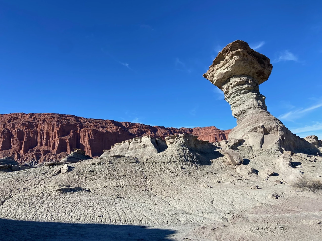 Image B Photo of a balanced rock in a desert canyon.