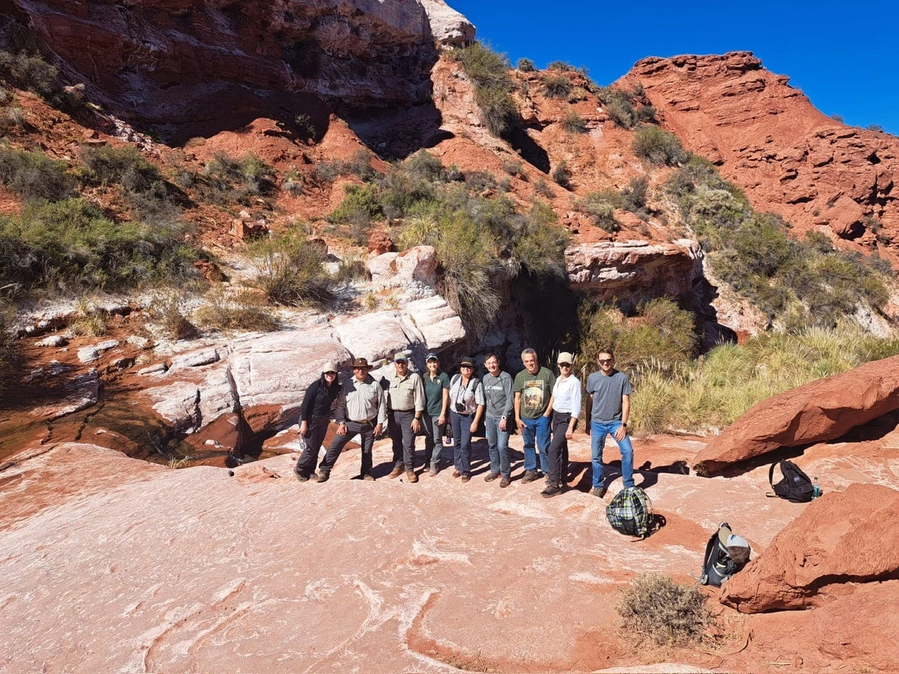 Image D Photo of a group of people in a desert canyon.