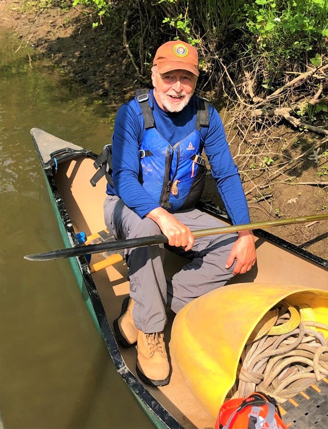 Individual Hartzog Award Recipient Rob Albrecht-Mallinger. A photo of volunteer Rob Albrecht-Mallinger siting in a canoe at Indiana Dunes National Park.