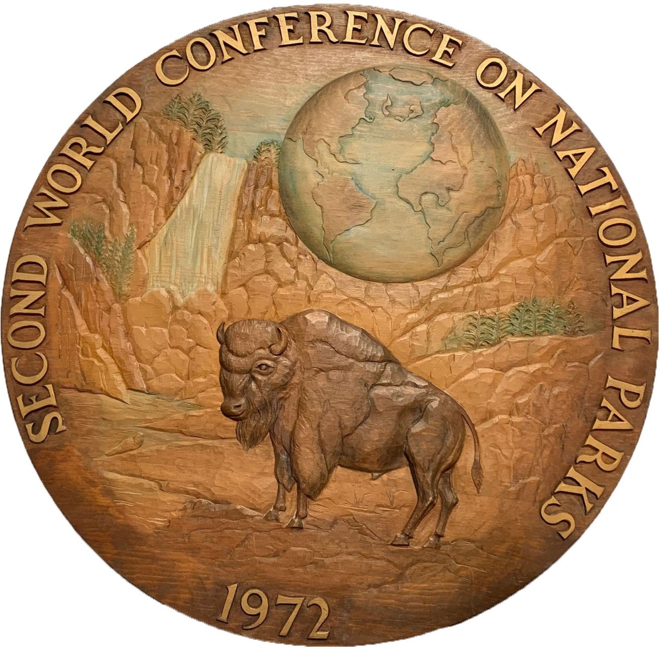 Second World Conference plaque Round carved wooden plaque with bison and waterfall
