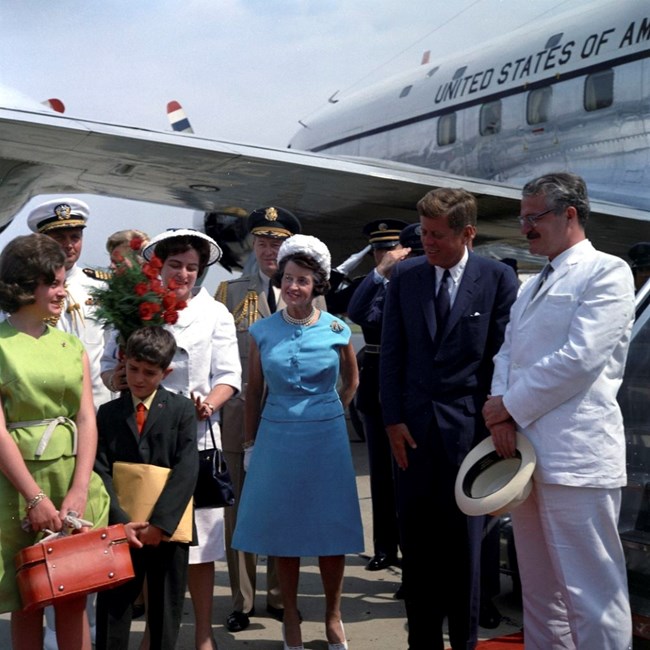 Rose Kennedy (center, in a blue dress) greets foreign dignitaries