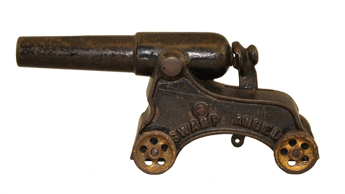 lt= metal toy cannon mounted on carriage with four wheels, side stamped SWAMP ANGEL