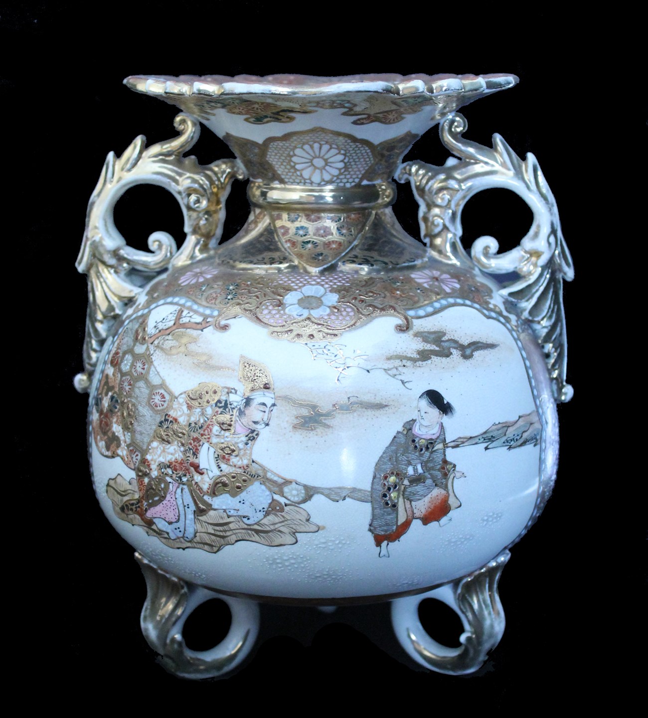 footed vase with round body and flared lip, decorated with scene of two figures and floral design