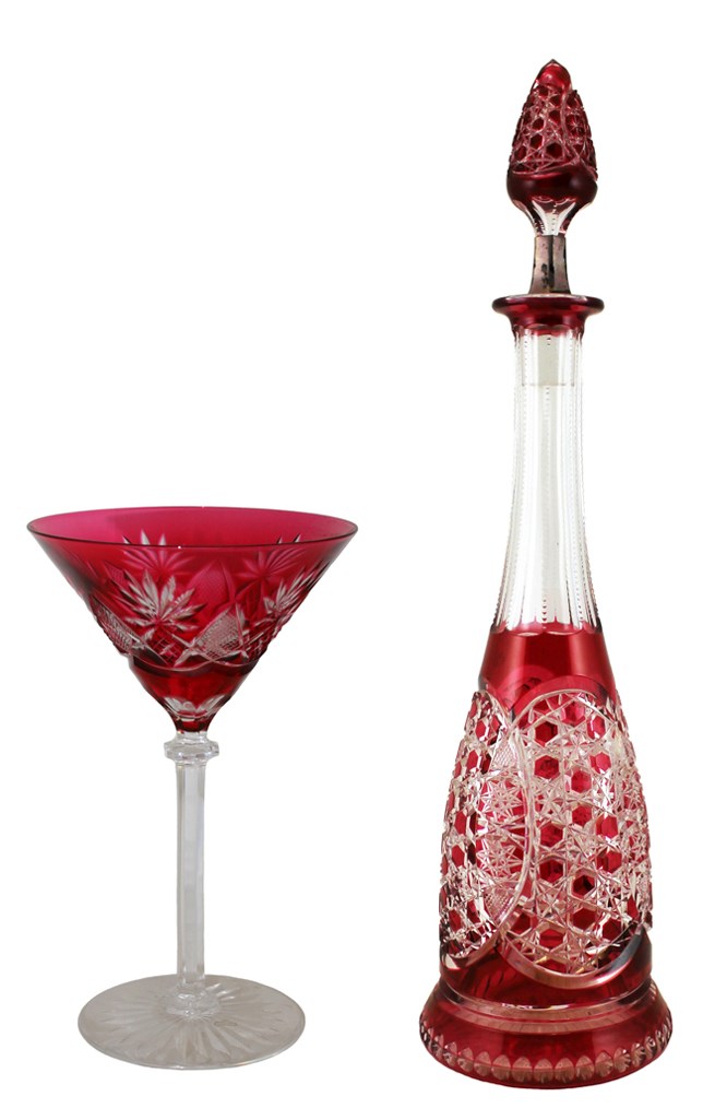 cocktail glass with red body on clear stem and foot with tall cut glass decanter with matching decoration