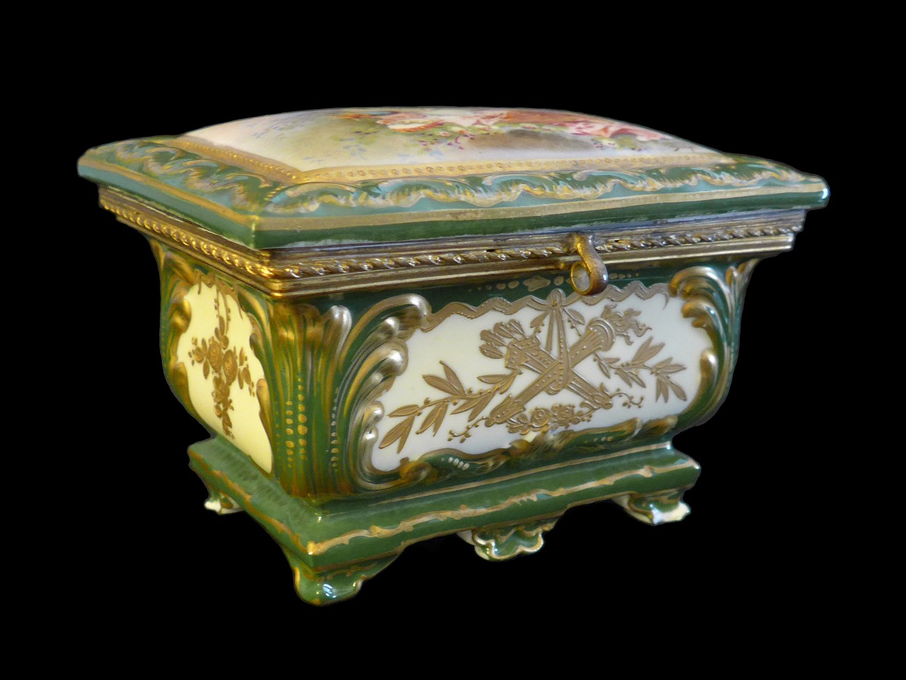 Ceramic lidded box decorated in cream, green, and gold